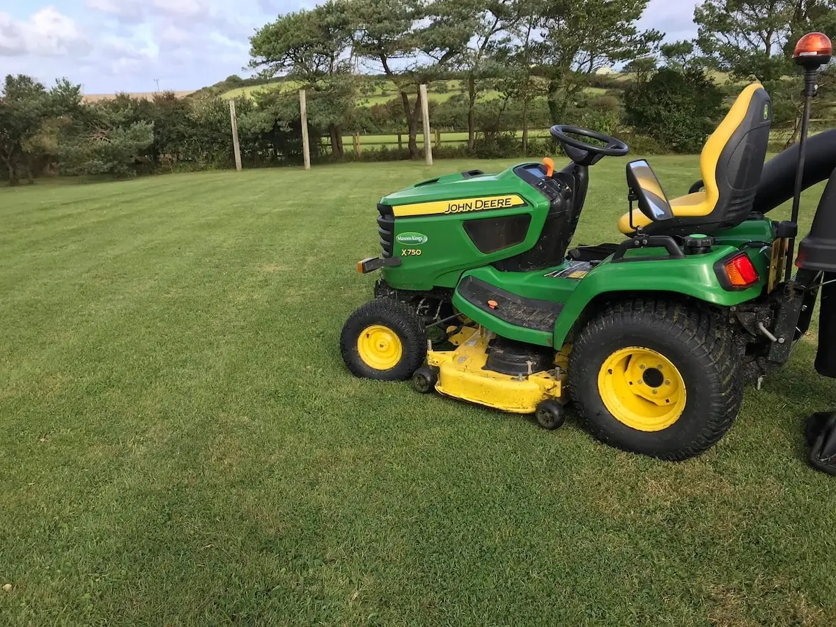 Ride-on mower on a large lawn near Port Isaac